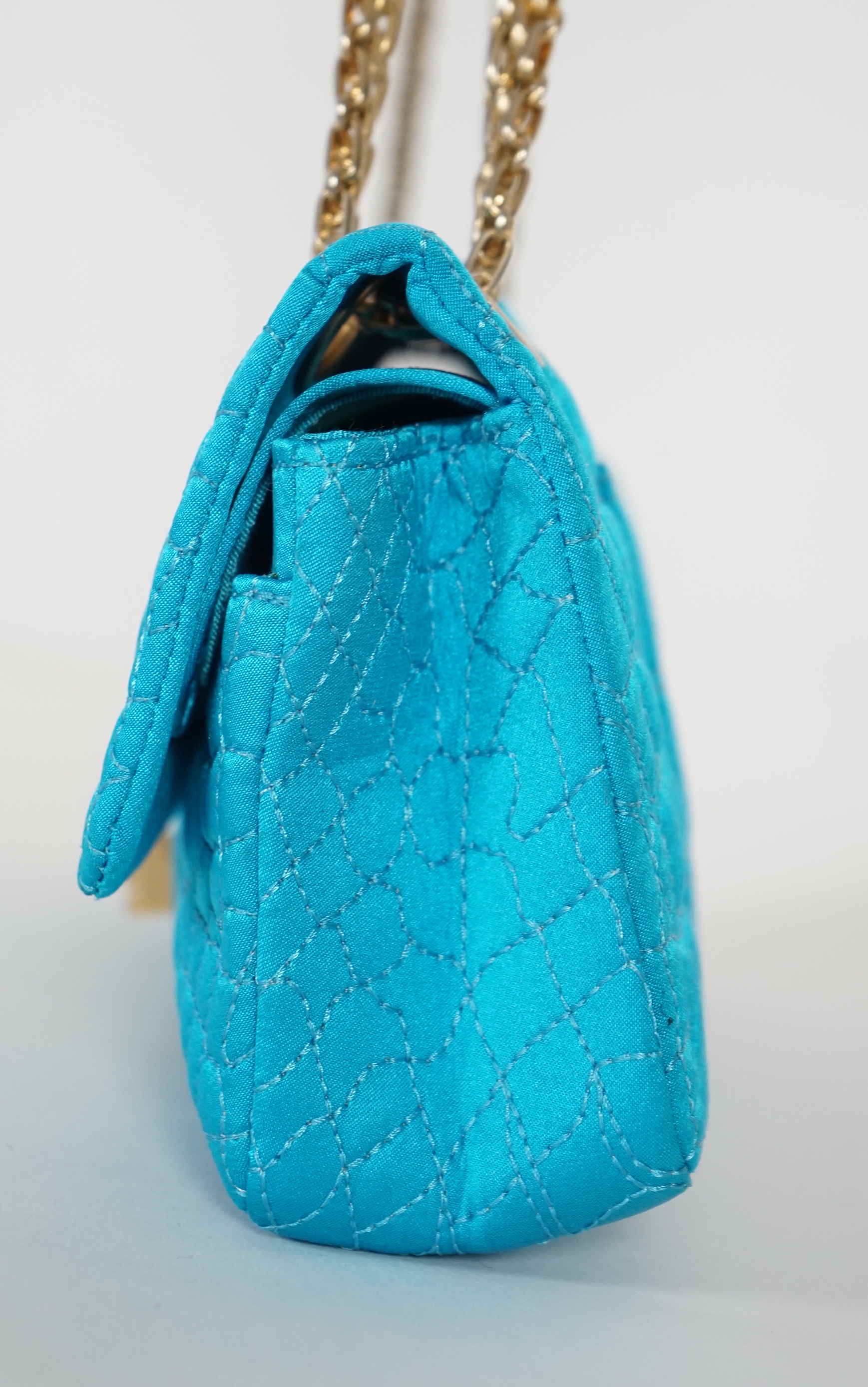 A Chanel medium-sized 2-55 bag in turquoise blue silk satin stitched with a quilted crocodile pattern, width 24cm, height 15cm, depth 6cm, Single handle 112cm, Double handles 65cm